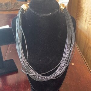 Black multi-strand piano wire necklace with gold-toned accents